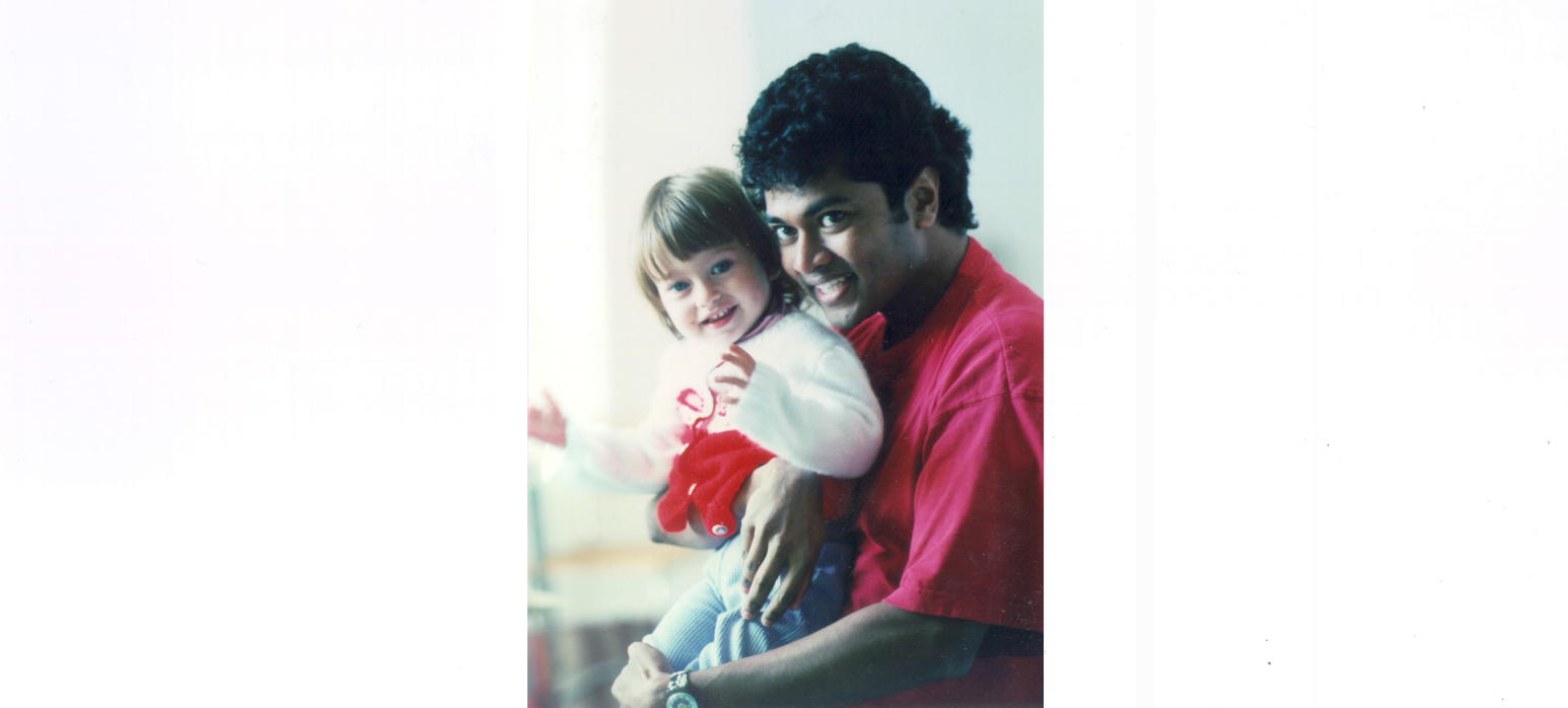 Partha Mitra holding a young Zoe Kleinfeld